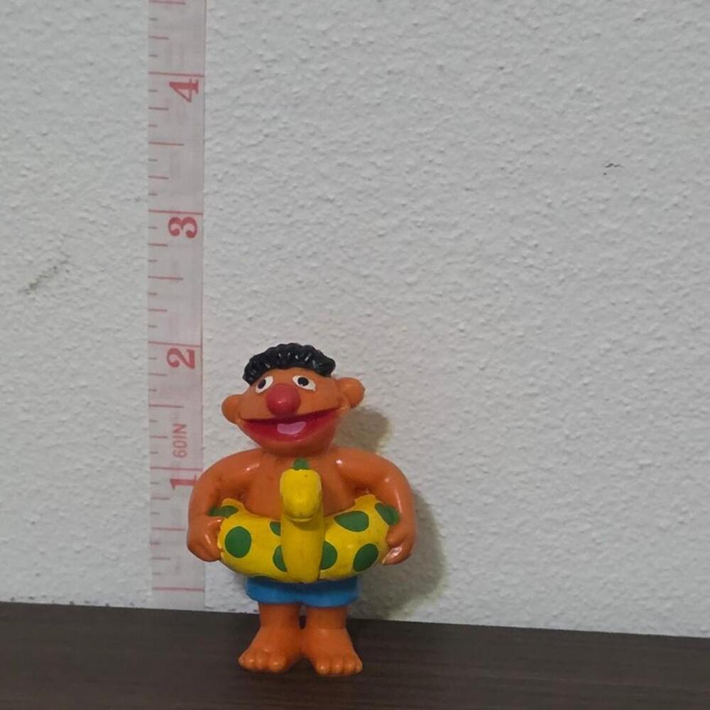 Sesame Street Ernie with green polka dots on yellow inflatable ring